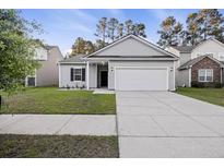 Charming single-story home with gray siding, well-manicured lawn, and an attached two-car garage at 278 Decatur Dr, Summerville, SC 29483