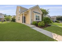 Charming two-story home with a well-manicured lawn and inviting front entrance at 344 Flyway Rd, Goose Creek, SC 29445