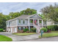 Inviting home featuring a charming porch with columns, a double staircase, and professional landscaping at 3567 Somerset Hills Ct, Mount Pleasant, SC 29466