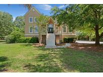 Inviting two-story home with a grand staircase leading to a charming front porch and lush landscaping at 3756 Colonel Vanderhorst Cir, Mount Pleasant, SC 29466