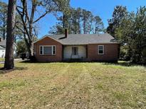 Charming brick home with a cozy front porch, offering classic curb appeal and a welcoming entrance at 502 May St, Saint George, SC 29477