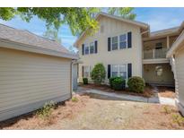 Charming two-story condo with light siding, black shutters, and a well-maintained lawn at 5554 Colonial Chatsworth Cir, North Charleston, SC 29418