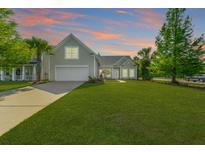 Charming home with a well-manicured lawn, beautiful landscaping, and a two-car garage at 7601 Stargazer Dr, Hanahan, SC 29410
