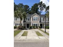 Charming townhomes with well-maintained landscaping, black shutters, and inviting front entrances at 9032 Maple Grove Dr, Summerville, SC 29485