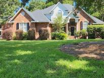 Charming brick home with manicured lawn and lush landscaping at 1349 Chrismill Ln, Mount Pleasant, SC 29466