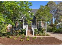 Charming single-story home with meticulously landscaped front yard and inviting entrance at 1516 Village Sq, Mount Pleasant, SC 29464