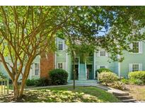 Charming two-story condo with light-green siding, white-trimmed windows, a brick chimney, and well-kept landscaping at 2010 Coldspring Dr # 502, North Charleston, SC 29406