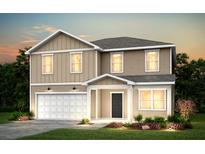 Charming two-story home with a gray roof, tan siding, manicured lawn, and a two-car garage at 202 W Bradford Pointe Drive Dr, Summerville, SC 29483