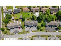 An aerial view shows a townhouse complex with assigned parking and partial tree coverage at 259 Pine Shadow Dr, Goose Creek, SC 29445