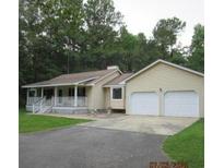 Inviting ranch-style home with a charming front porch and a two-car garage on a large lot at 302 Summerset Ln, Summerville, SC 29483