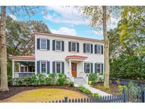 Charming two-story home with white siding, black shutters, and a vibrant red roof at 305 N Civitas St, Mount Pleasant, SC 29464