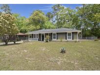 Charming single story home with a covered front porch and well-maintained lawn at 3308 Comsee Ln, Johns Island, SC 29455