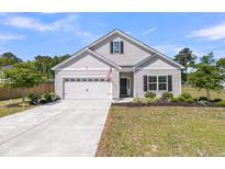 Charming single-Gathering home with manicured lawn and attached two-car garage at 707 Butter Rd, Bonneau, SC 29431