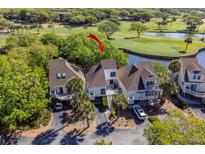 Beautiful elevated angle of the condo showing landscaping, updated roof, and stunning golf course and water views at 732 Spinnaker Beachhouse, Seabrook Island, SC 29455