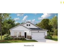 Charming single-story home showcasing a welcoming two-car garage and manicured front yard at 1033 Sagegrass St, Summerville, SC 29485