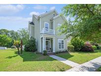 Charming two-story home featuring a quaint balcony, manicured lawn, and inviting front entrance at 117 Blue Bonnet St, Summerville, SC 29483