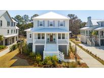 Charming two-story home with a large front porch, white railings, and manicured landscaping at 1604 Bernier Commons, Johns Island, SC 29455