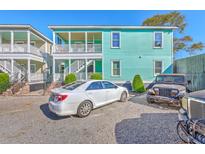 Charming two-story home with a gravel driveway and a light blue exterior at 172 Saint Philip St # F, Charleston, SC 29403