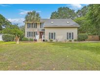 Two-story home with a well-manicured lawn and palm tree at 2275 Pristine View Rd, Charleston, SC 29414