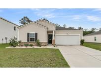 Charming single-Gathering home features a two-car garage and manicured lawn in a quiet neighborhood at 313 Squire Pope Rd, Summerville, SC 29486