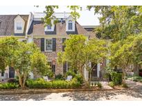 Charming brick home with dormer windows, mature trees, and an inviting entrance at 39 N Adgers Wharf, Charleston, SC 29401