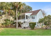 Charming coastal home featuring a screened porch, elevated design, and lush landscaping at 507 Cobby Creek Ln, Seabrook Island, SC 29455