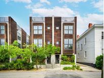 Stunning modern townhome with a wood facade, private rooftop terrace, and professionally landscaped entryway at 62 Gadsden St # A, Charleston, SC 29401