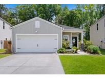 Charming single-story home with a two-car garage, landscaped yard, and a welcoming front entrance at 655 Jancus St, Charleston, SC 29414