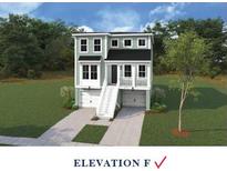 Charming two-story home with a welcoming staircase, double garages and pleasant green exterior at 752 Minton Rd, Charleston, SC 29412