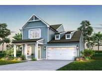 Charming new construction with a covered porch, garage, and landscaped yard at 1034 Marsh Harrier Dr # Cc3-4-3, Ravenel, SC 29470