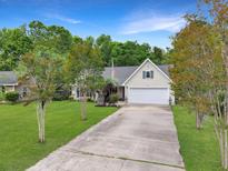Charming home with a manicured lawn and a long drive, creating a welcoming approach at 1061 Reverend Joseph Heyward Rd, Charleston, SC 29414