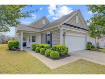 Charming single-story home with manicured lawn and attached two-car garage at 118 Billowing Sails St, Summerville, SC 29486