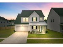 Charming two-story home with a well-manicured lawn, attached garage, and inviting front porch at 1226 Spotflower St, Summerville, SC 29485
