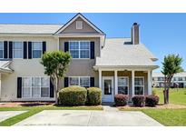 Charming townhome featuring neutral siding, black shutters, and well-maintained landscaping at 132 Lynches River Dr, Summerville, SC 29485
