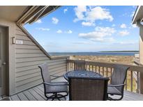 Relax on the cozy balcony with seating and views of the ocean and sky at 1332 Pelican Watch Villas, Seabrook Island, SC 29455