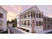 Stunning two-story home with a balcony and beautiful white siding and a quaint front door at 134 Spring St, Charleston, SC 29403
