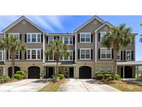Inviting townhome with a meticulously maintained lawn and mature palm trees enhancing its curb appeal at 1349 Hamlin Park Cir, Mount Pleasant, SC 29466