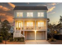 Charming two-story home with a welcoming front porch and a two-car garage under the main structure at 1464 Stratton Pl, Mount Pleasant, SC 29466