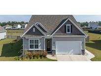 Charming single-Gathering home featuring a two-car garage and neutral siding at 312 Cypress Branch Rd, Huger, SC 29450