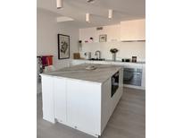 Bright kitchen featuring a central island with marble countertop and modern cabinetry at 330 Concord St # 5D & 5E, Charleston, SC 29401