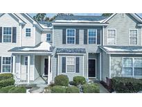 Inviting townhouse with blue siding, black shutters and minimal snow accents at 333 Flyway Rd, Goose Creek, SC 29445