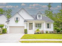 Charming white two-story home with inviting front porch and well-manicured lawn at 3439 Toomer Kiln Cir, Mount Pleasant, SC 29466