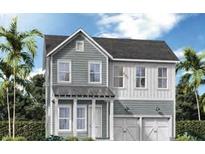 Charming two-story home featuring gray siding, white trim, and a two-car garage in a lush, tropical setting at 360 Trailmore Ln, Summerville, SC 29486