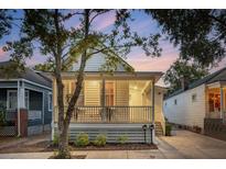 Charming single-story home featuring a cozy front porch, tidy landscaping, and a welcoming curb appeal at 5 Addison St, Charleston, SC 29403
