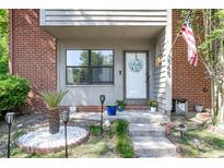 Inviting front porch with red brick and landscaped garden, complete with an American flag at 565 Travelers Blvd, Summerville, SC 29485