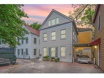 Charming home featuring a two-story design with a gravel driveway and a covered parking area at 9 Bogard St # 3, Charleston, SC 29403