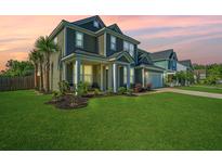 Inviting two-story home with a lush green lawn, well-manicured landscaping, and a welcoming front porch at 101 Firebrick Way, Summerville, SC 29483