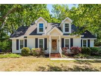 Charming home featuring dormer windows, a brick walkway, and mature landscaping at 1070 Blue Marlin Dr, Charleston, SC 29412
