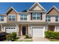 Charming townhouse with a well-maintained yard, attached garage, and inviting curb appeal at 118 Alpine Rd, Summerville, SC 29485