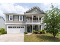 Charming two-story home with a welcoming front porch and a well-maintained lawn at 138 Shadybrook Dr, Summerville, SC 29486